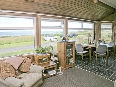 a living room with a couch and a table at Braemar in Lendalfoot