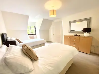 a bedroom with two beds and a dresser at Lochindaal - Beautiful, Spacious 4 Bedroom House in Kintyre in Whitehouse