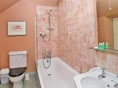 a bathroom with a shower and a toilet and a sink at Marwhin House - Swwr in Kirkpatrick Durham