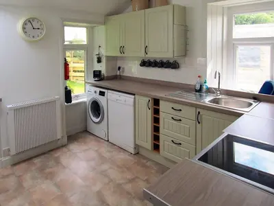 a kitchen with a sink and a washing machine at Dunmaghlas in Pirnmill