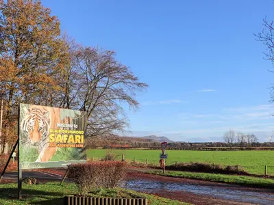 a sign in a field with a tiger on it at Rob Roy Apartment in Stirling