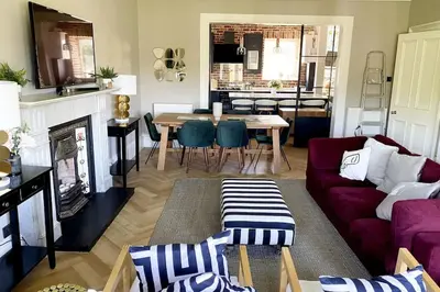 a living room with a couch and a table at Stunning 3 bedroom Victorian home near Pollok country park in Glasgow