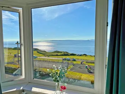 a window with a view of the ocean at Aird Cottage in Dunure