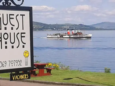 a large boat on a large body of water with a sign at Douglas Park Guest House in Dunoon
