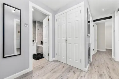 a bathroom with a white door and a mirror at The Riverside Rest 1 in Stirling