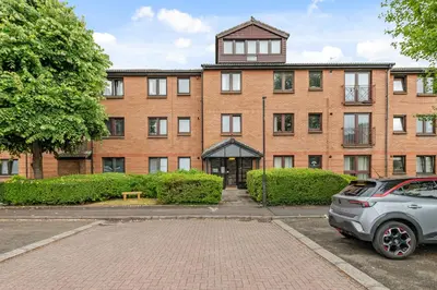 a brick building with a car parked in front of it at The Riverside Rest 1 in Stirling