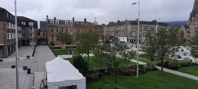 a tent in the middle of a city with buildings at Snug - Colquhoun Square Apartment in Helensburgh
