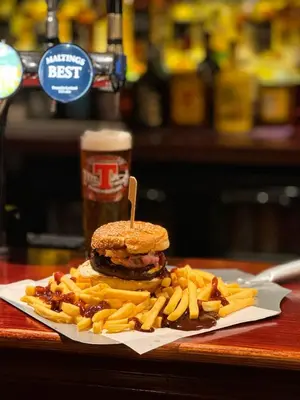 a sandwich and french fries on a plate with a drink at Maltings Hotel in Dunfermline