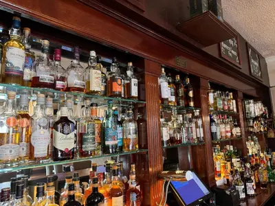 a bar filled with lots of bottles of alcohol at Maltings Hotel in Dunfermline