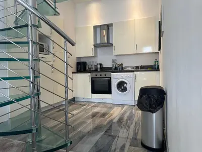 a kitchen with a washer and dryer in a room at Seaside Home in Ardeer Square