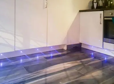 an empty room with blue lights on the floor at Seaside Home in Ardeer Square