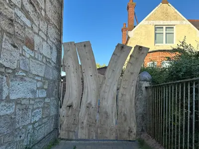 a wooden fence in front of a house at Seaside Home in Ardeer Square