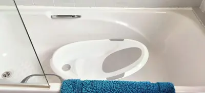 a toilet in a bathroom with a blue rug at Parkside 2 bedrooms appartment with encolsed garden in Largs