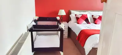 a small bedroom with a bed and a ladder in it at Parkside 2 bedrooms appartment with encolsed garden in Largs
