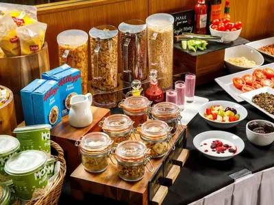 a table with jars of food and other food items at Mercure Glasgow City Hotel in Glasgow