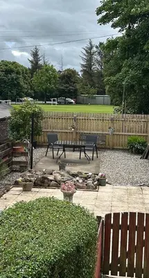 a patio with a picnic table and a fence at Loch Lomond Apartment in Alexandria