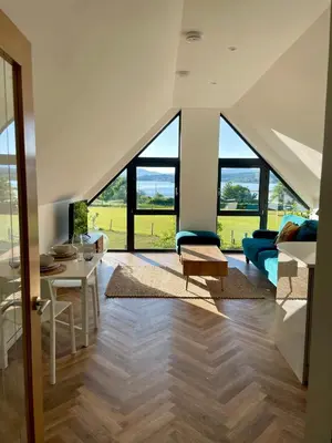 a large living room with large windows and a couch at Còsagach Flat near Oban in Barcaldine
