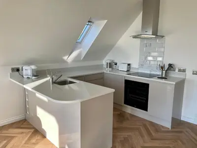 a white kitchen with a sink and a stove at Còsagach Flat near Oban in Barcaldine