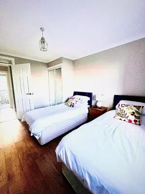a bedroom with two beds and a window at 3 Bedroom harbourside apartment, Queensferry, 10 miles from Edinburgh in Queensferry