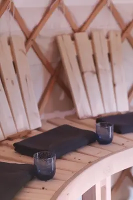 a wooden table with two cups on top of it at Eastside Steading - Family barn in the Pentland Hills, Edinburgh in Penicuik