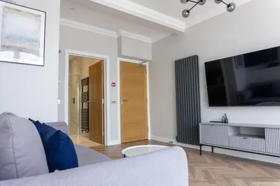 a living room with a couch and a flat screen tv at Oban Apartments in Oban