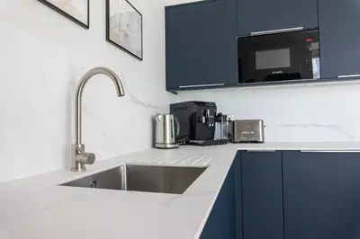 a kitchen with a sink and a microwave at Oban Apartments in Oban