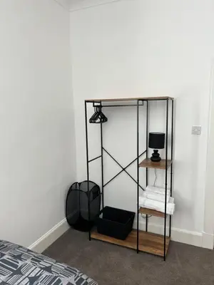 a room with a bed and a glass shelf at 1L Albert Place Maddiston Road Brightons Falkirk FK2 0JX in Polmont