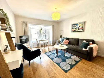 a living room with a couch and a table at City Centre Hidden Hideout for 2 in Edinburgh