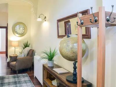 a living room with a globe on a table at Sorbie Villa in Stevenston