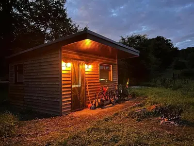a small cabin with two bikes parked outside of it at Craigengillan Mini Lodge in Dalmellington