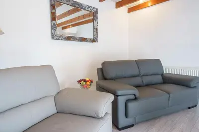 a living room with a couch and a chair at Morton Cottage in Thornhill