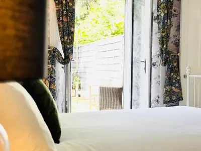 a bedroom with a bed and a window at City Centre Escape with Private Garden in Edinburgh