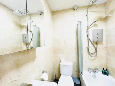 a bathroom with a shower and a toilet and a sink at City Centre Escape with Private Garden in Edinburgh