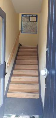 a staircase in a room with a door and a stair case at Stunning Village Centre Holiday Home in Callander