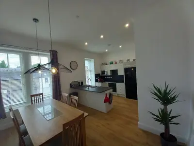 a kitchen and living room with a table and a dining room at Stunning Village Centre Holiday Home in Callander