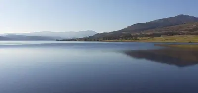 a large body of water with mountains in the background at Stunning Village Centre Holiday Home in Callander