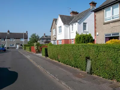 a street in a residential neighborhood with houses at Private Entrance GF 2 bed flat near Renfrew Centre - Pass the Keys in Renfrew
