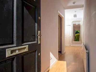 a black door leading into a hallway with a hallway at Private Entrance GF 2 bed flat near Renfrew Centre - Pass the Keys in Renfrew