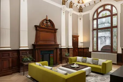 a living room with two couches and a fireplace at AC Hotel by Marriott Glasgow in Glasgow