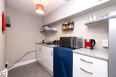 a small kitchen with a counter with a microwave at New Town Rooms in Edinburgh