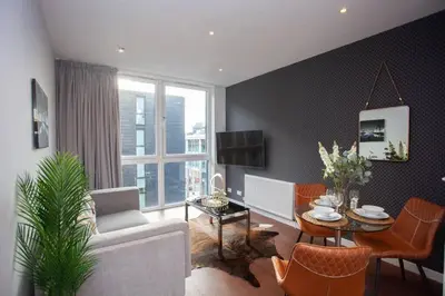 a living room with a couch and a table at 1 Bedroom Apartment in Very Central Location in Glasgow