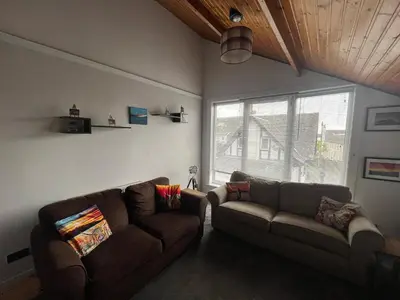 a living room with two couches and a window at The Mail Barn Studio in Lamlash