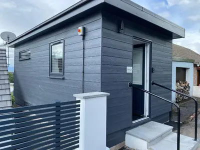 a blue tiny house with a staircase in front at Benollis in Oban