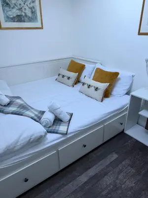 a white bed with pillows on top of it at Very Central, Charlotte Square, near the Castle in Edinburgh