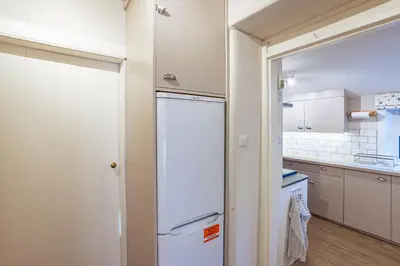 a kitchen with a white refrigerator in a room at Kenmure Kennels in New Galloway