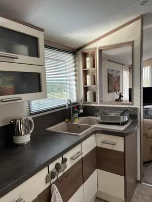 a kitchen with a sink and a counter top at Maneight Luxury Lodge with hot tub in New Cumnock
