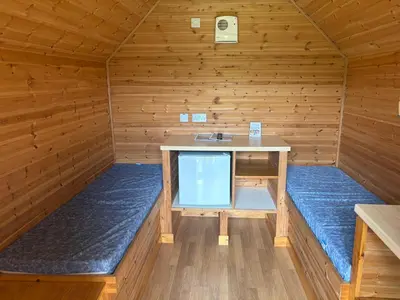 a wooden room with a desk in a sauna at Cruachan Caravan and Camping Farm in Killin