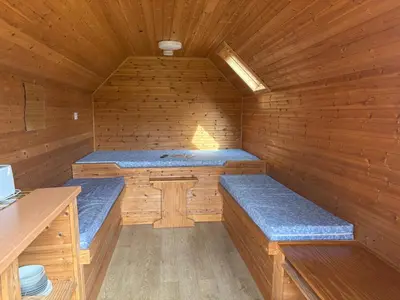 a sauna with wooden walls and benches in a cabin at Cruachan Caravan and Camping Farm in Killin