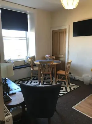 a dining room with a table and chairs in a room at Central 3 bedrooms apartment for upto 6 in Edinburgh
