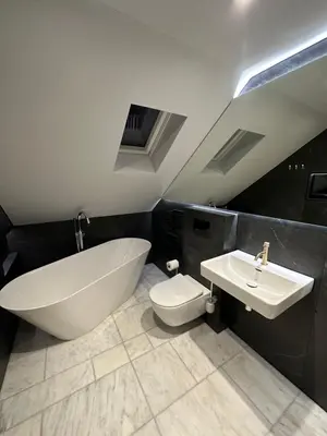 a bathroom with a tub and a toilet and a sink at Laurieston Penthouse in Grahamston
